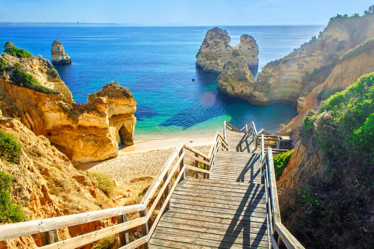 Wooden footbridge to beautiful beach Praia do Camilo near Lagos in algarve region, Portugal