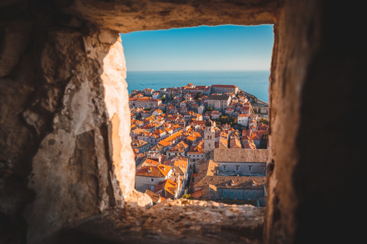 Panoramic view of the old town of Dubrovnik in beautiful golden evening light at sunset with blue sky in summer, Dalmatia, Croatia