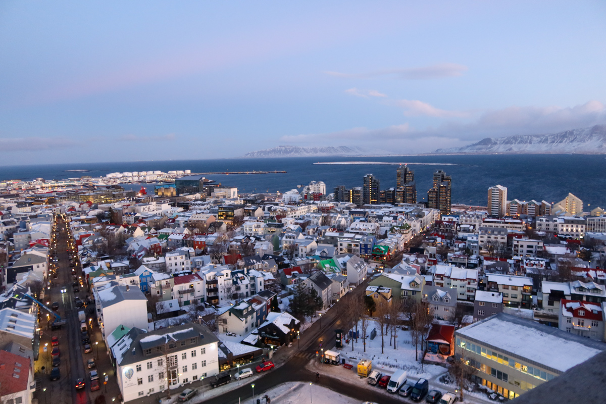 View of Reykjavik spreading out beneath you from the top of the Hallgrimskirkja, as the sun begins rising on a winter's day.