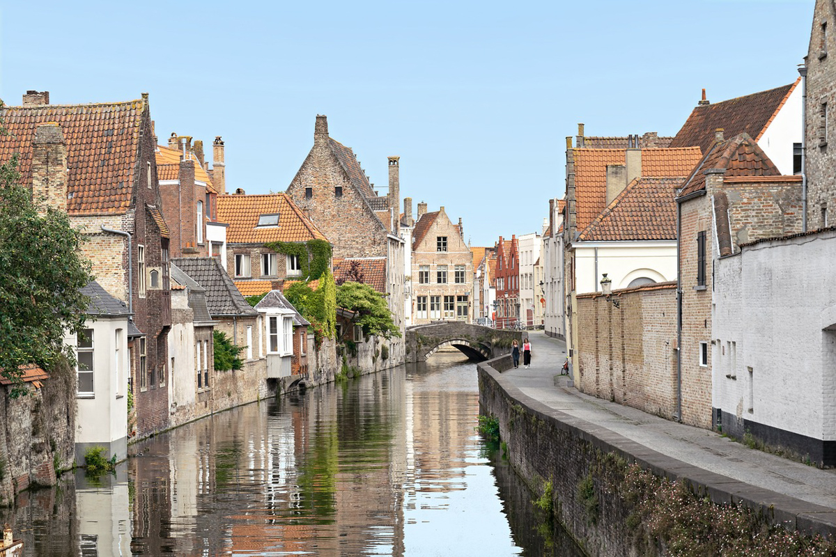 The city of Bruges, with houses on either side of a canal