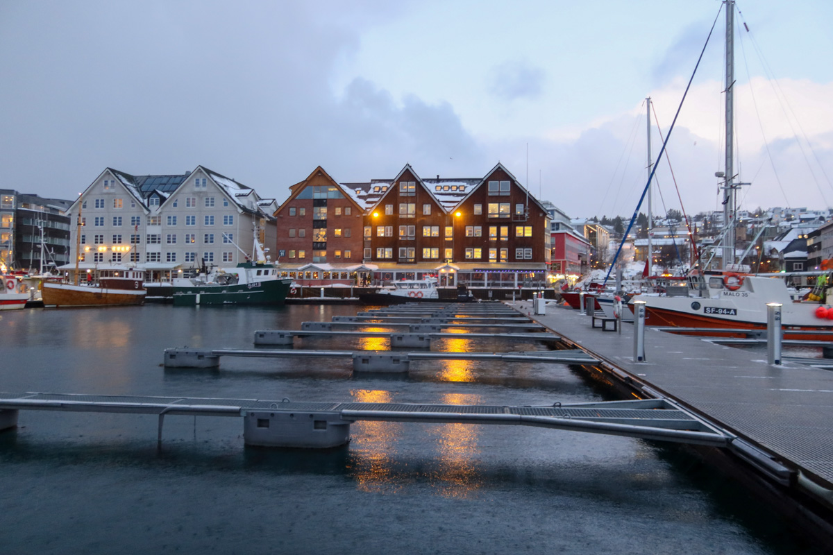 Lit up buildings in Tromso with a reflection over the water