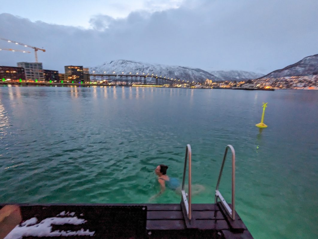 Swimming in the chilly arctic waters in February, outside of Pust sauna