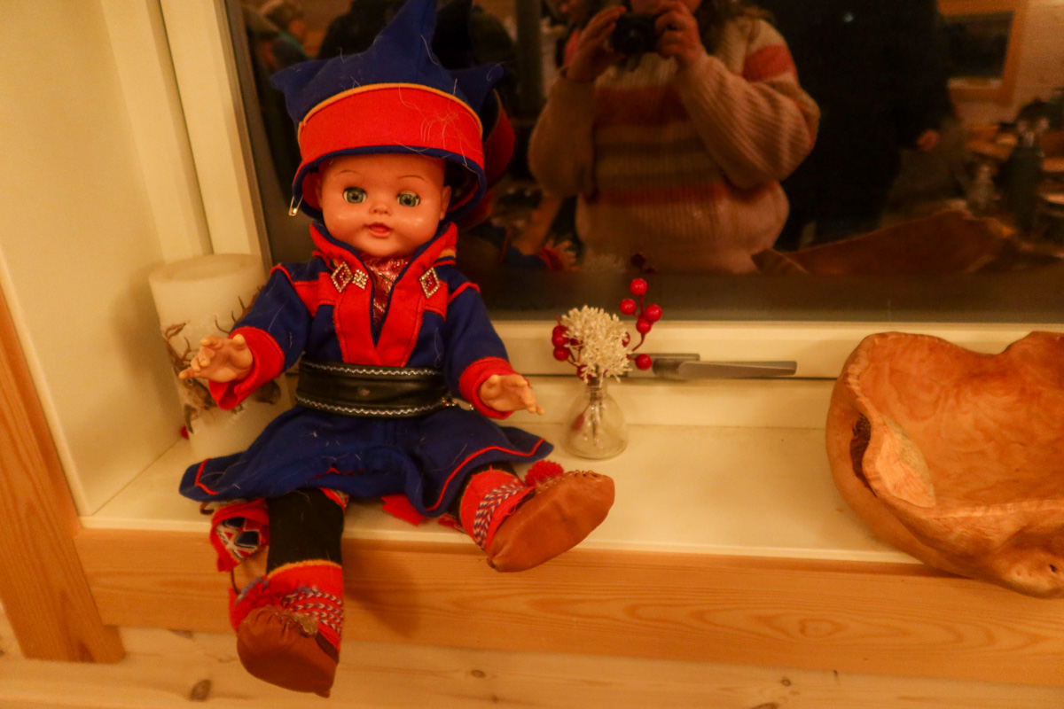 Sami doll wearing traditional dress in the hut