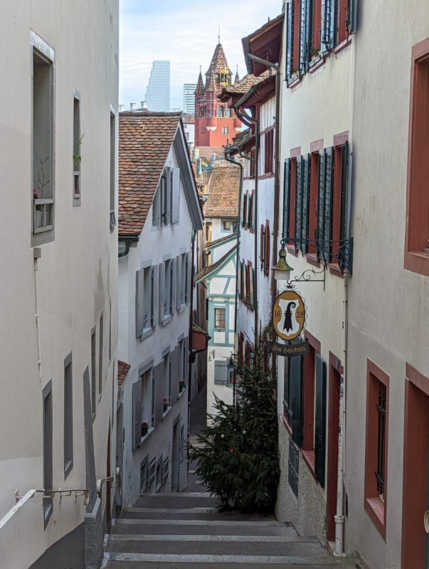 Looking down the streets in Basel with buildings in the background.