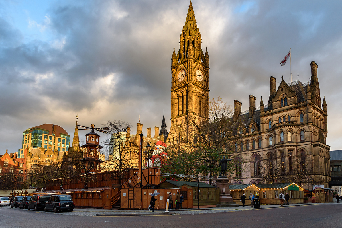 Long exposure photograph of the shoppers at the Christmas market in front of the Manchester Town Hall,