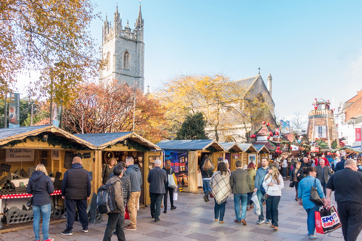 Cardiff, Wales, United Kingdom - November 19, 2017: People are visiting the Christmas Market in Cardiff City Centre on a sunny day in November 2017.