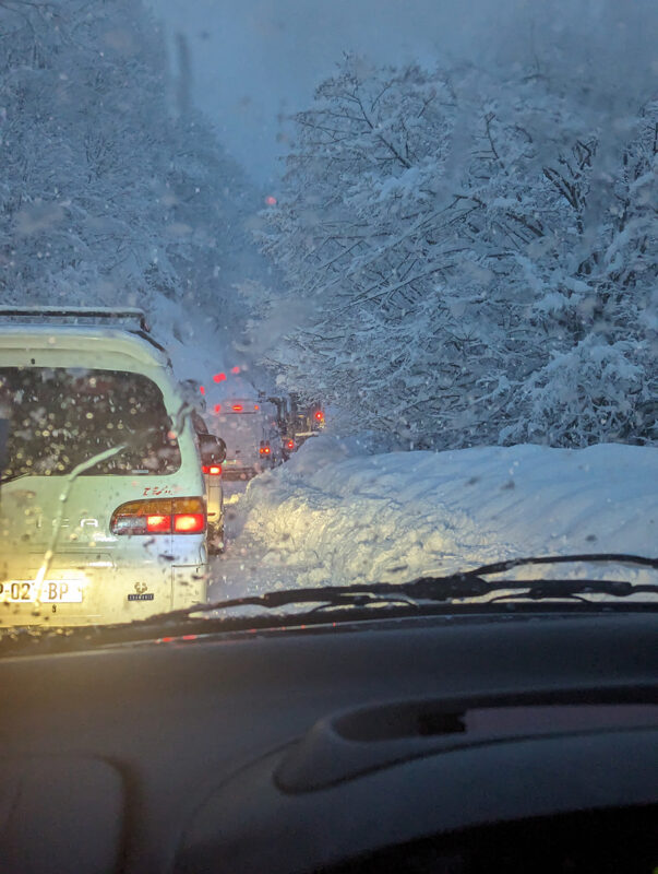 Queue of cars on road to Mestia, Georgia, in heavy snow.