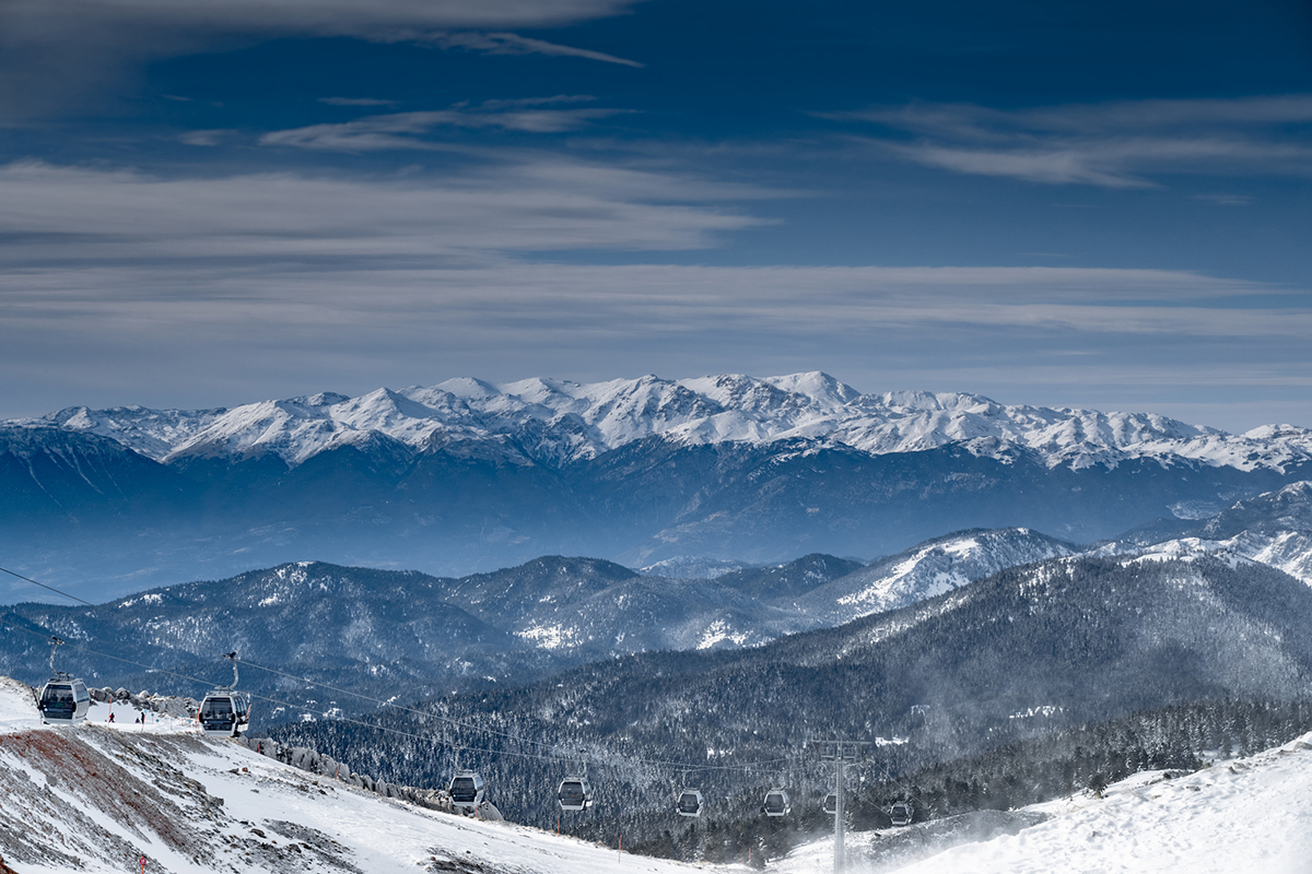 The famous snowed mountain of Parnassos with popular ski resort covered up in snow and unique nature, cable cabins, Voiotia, Greece